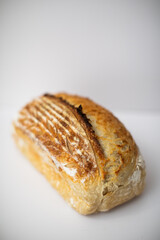 Homemade fresh baked sourdough crispy loaf bread on white background