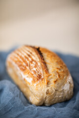 fresh closeup loaf of bread on beige and blue background 