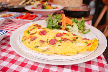 Delicious omelette served with fresh salad and side dishes
