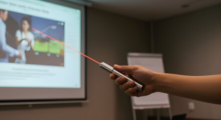 Close-up of hands holding laser pointer during slide presentation, focused on business or lecture