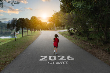 Young girl running towards a bright future on a scenic path marked 2026 start with serene nature...