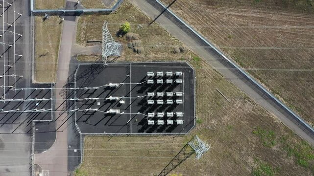 4K aerial drone footage of large electric power substation and high voltage power lines in Hillsboro Oregon, showing transmission towers, transformers, and distribution infrastructure from above