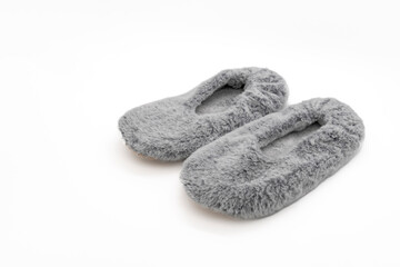Fluffy gray home slippers isolated on white background. Bed shoes accessory footwear.