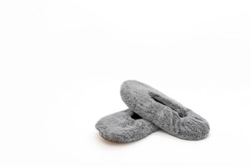 Fluffy gray home slippers isolated on white background. Bed shoes accessory footwear.