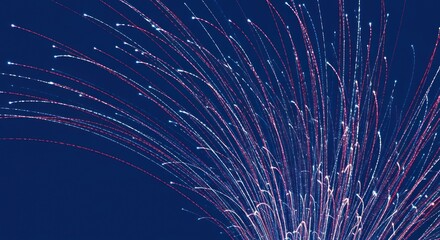 Abstract Fireworks Display with Red and White Trails on a Deep Blue Background