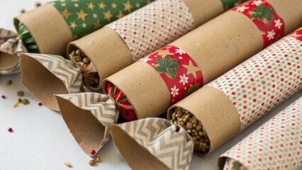 Eco Friendly Christmas Party Concept. Colorful Christmas crackers arranged on a table, featuring festive patterns and textures, ready for celebration.