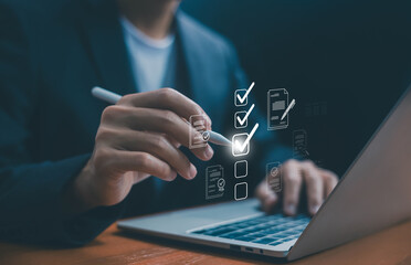 Business professional using a laptop and a stylus with digital checklist icons, symbolizing task management, project planning, productivity, workflow, effective business organization. online checklist
