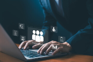 Businessman typing on laptop with digital icons of employee benefits, salary, family support,...