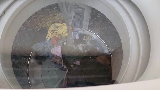 top view of a top-loading washing machine in water filling or soaking mode