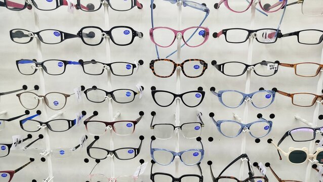 Image of a glasses showcase at the modern optic shop, nobody. dioptric glasses on the shelf of an optometric clinic and glasses store. Professional help and advice. Frames for eyeglasses in an opticia