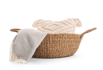 Wicker basket with cushion and blanket isolated on white background