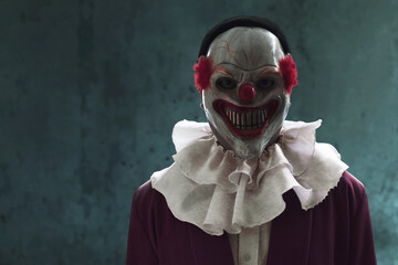 Man wearing scary clown mask, Halloween theme