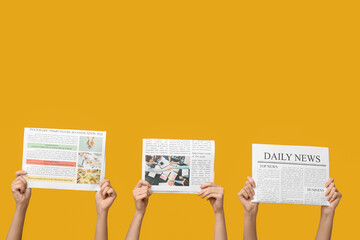 Women with newspapers on yellow background