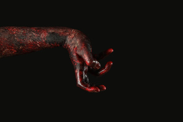Hand of zombie on black background. Halloween celebration