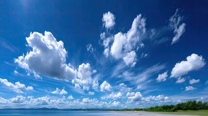 Vibrant Blue Sky Panorama with Fluffy White Clouds Over Tropical Coastline Clear Skies Sunlight and Green Vegetation Natural Beauty Aerial Perspective