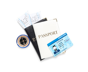 Passports with tickets, compass and driving license on white background