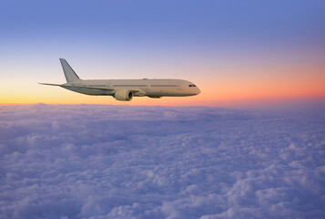 White passenger airplane flying in the sky amazing clouds in the background at sunset - Travel by air transport