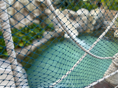 Fototapeta Rope Bridge Netting Above Outdoor Pool