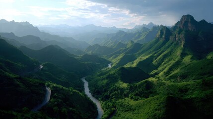 Naklejka premium Lush Green Mountain Range with Winding River Valley