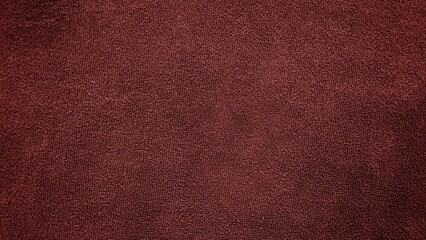 Clean and smooth dark brown towel fabric texture pattern. Soft dark brown towel texture background. Fluffy brown towel surface.
