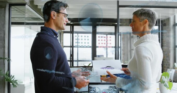 Design team discussing car sketch displaying holograms on transparent glass and reviewing AR drive