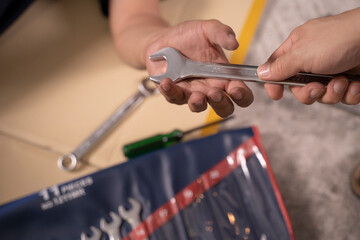 Two handsome mechanics are working together on a car repair.