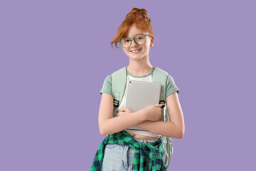 Cute schoolgirl with modern tablet computer and backpack on lilac background
