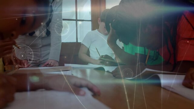 Teacher guiding children finishing notes in notebooks while animated study icons drifting
