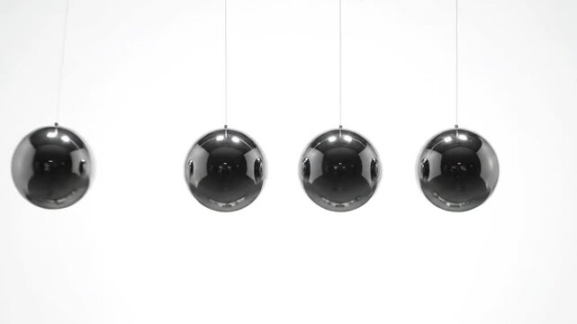 Four shiny black pendulums hanging in a row against a white background with a minimalist aesthetic.