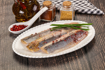 Salted marinated herring fillet with spices
