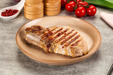 Grilled pork loin steak with bone