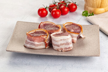Raw pork tenferloin with bacon