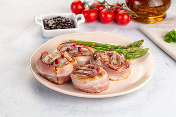 Tasty grilled pork medallion with bacon