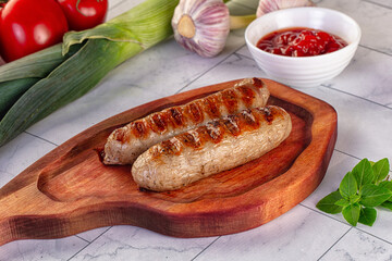 Grilled pork sausages served tomato sauce
