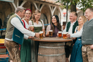 Cheerful group of friends in Bavaria raise beer mugs in a traditional beer garden celebrating German culture friendship and festive joy