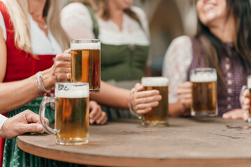 Beer mugs clinking close up in Bavarian beer garden capturing fun leisure German tradition friendship and festive Oktoberfest celebration