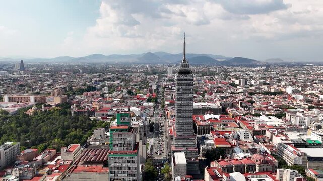 Backwards drone of eje central in mexico city near torre Latino