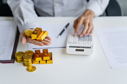 businessman investor holding gold as traditional safe haven asset in volatile economic conditions