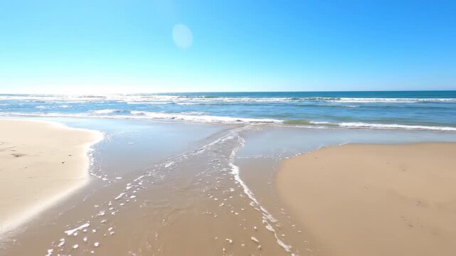 The ocean tide dramatically recedes and returns on a sandy beach, revealing and covering the shore over time evolution, motion, terrain
