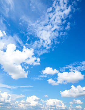 A vibrant blue sky scattered with fluffy white clouds