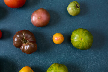 Variety of heirloom tomatoes on blue background
