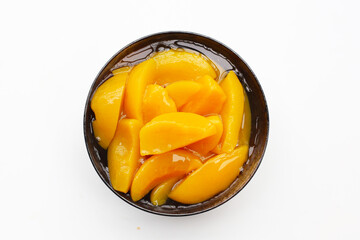 Sliced peaches in syrup served in a bowl