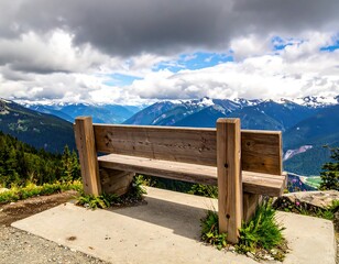 Wooden bench overlooking a majestic mountain range under a partly cloudy sky