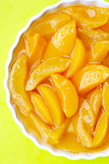Sliced peaches in syrup served in a bowl