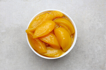 Sliced peaches in syrup served in a bowl