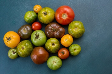 Assorted heirloom tomatoes on blue background
