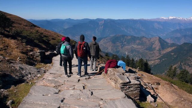 Mountain peak summit with hiking trails under a bright afternoon sky. Video captured at Chopta Tungnath, Chandrashila Trek, Himalayas, Uttarakhand, India.