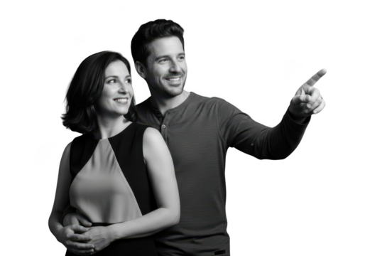 Smiling couple pointing together in black and white isolated on transparent background