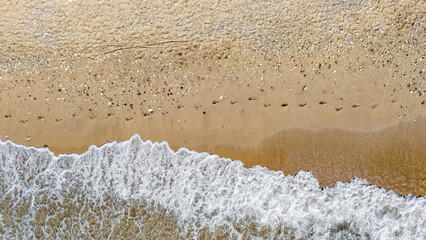 Aerial drone view of sandy beach and turquoise sea waves background, holiday vacation concept, Antalya Konyaalti beach, Turkey