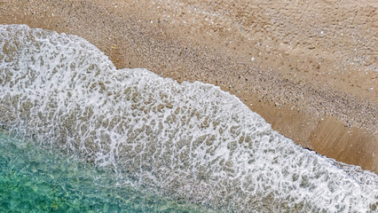 Aerial drone view of sandy beach and turquoise sea waves background, holiday vacation concept, Antalya Konyaalti beach, Turkey